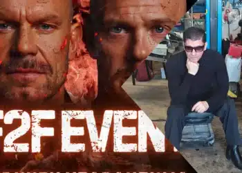 Vartti Isberg istuu autotallissa mustissa vaatteissa ja aurinkolaseissa, käsi leuan alla.